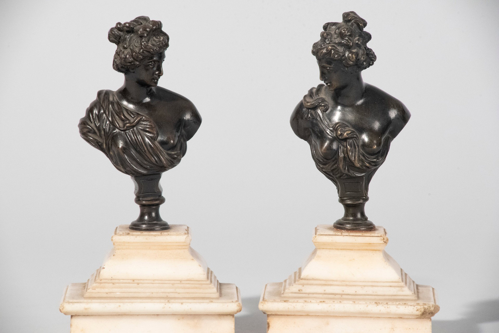 French School, 18th century, Pair of small female busts, bronze with marble pedestal